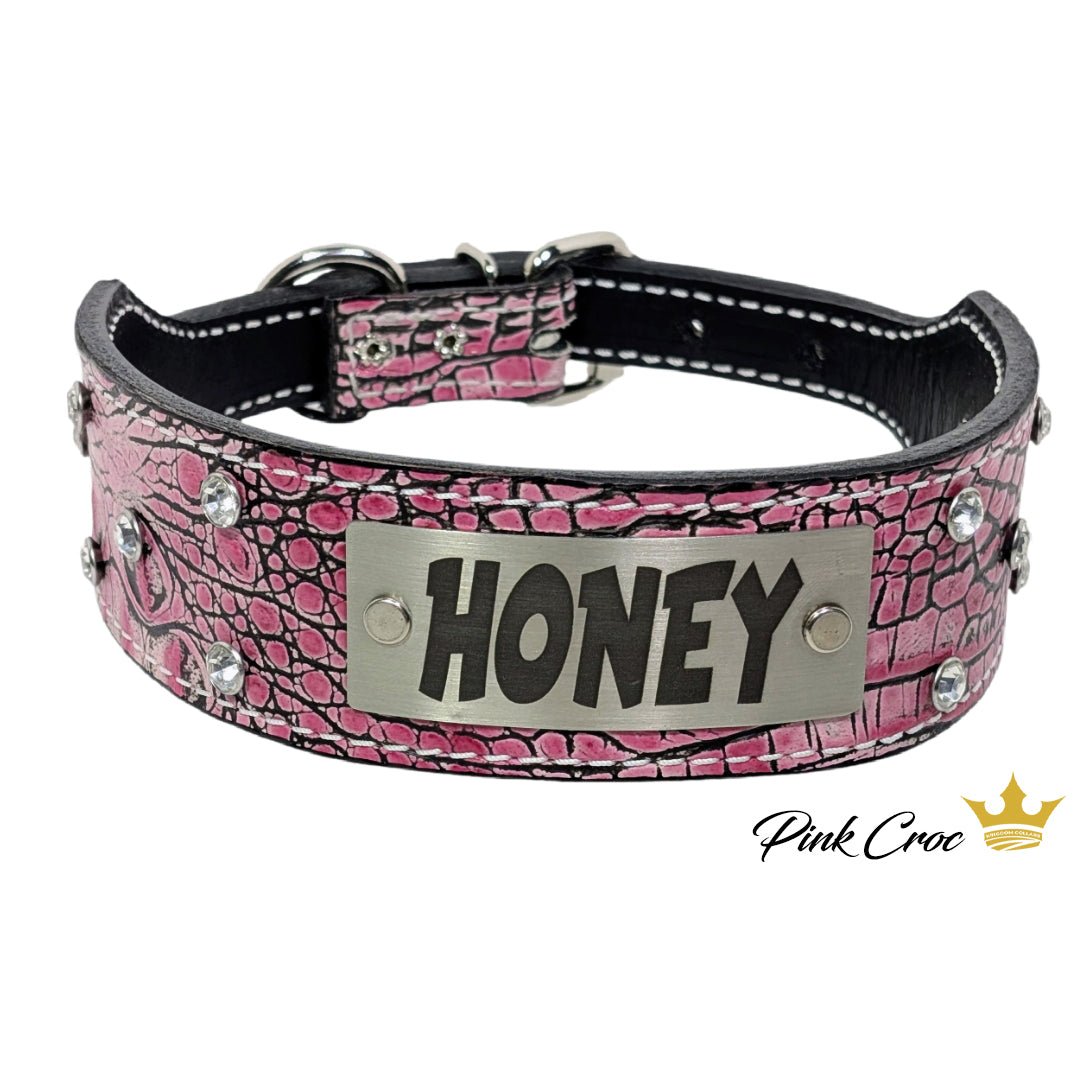 Pink crocodile-patterned dog collar with 'HONEY' tag on a white background