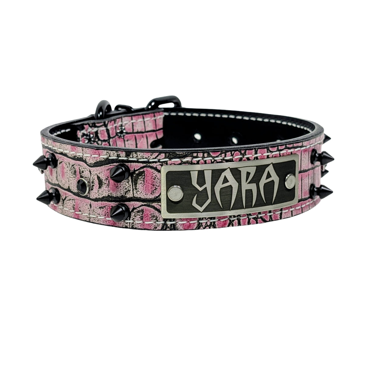 Pink camouflage dog collar with black spikes and a nameplate on a white background