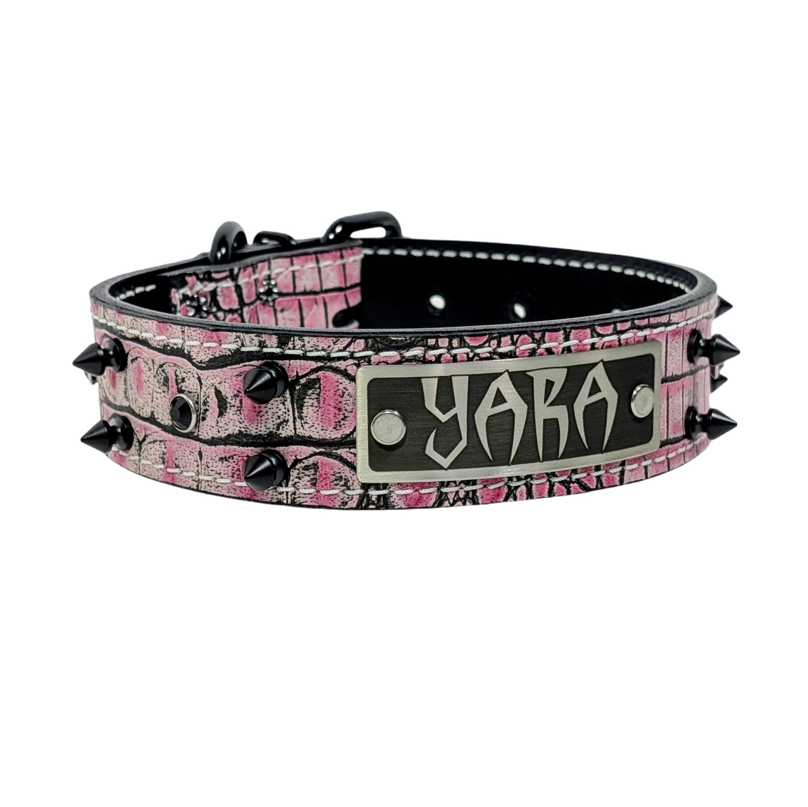 Pink camouflage dog collar with black spikes and a nameplate on a white background