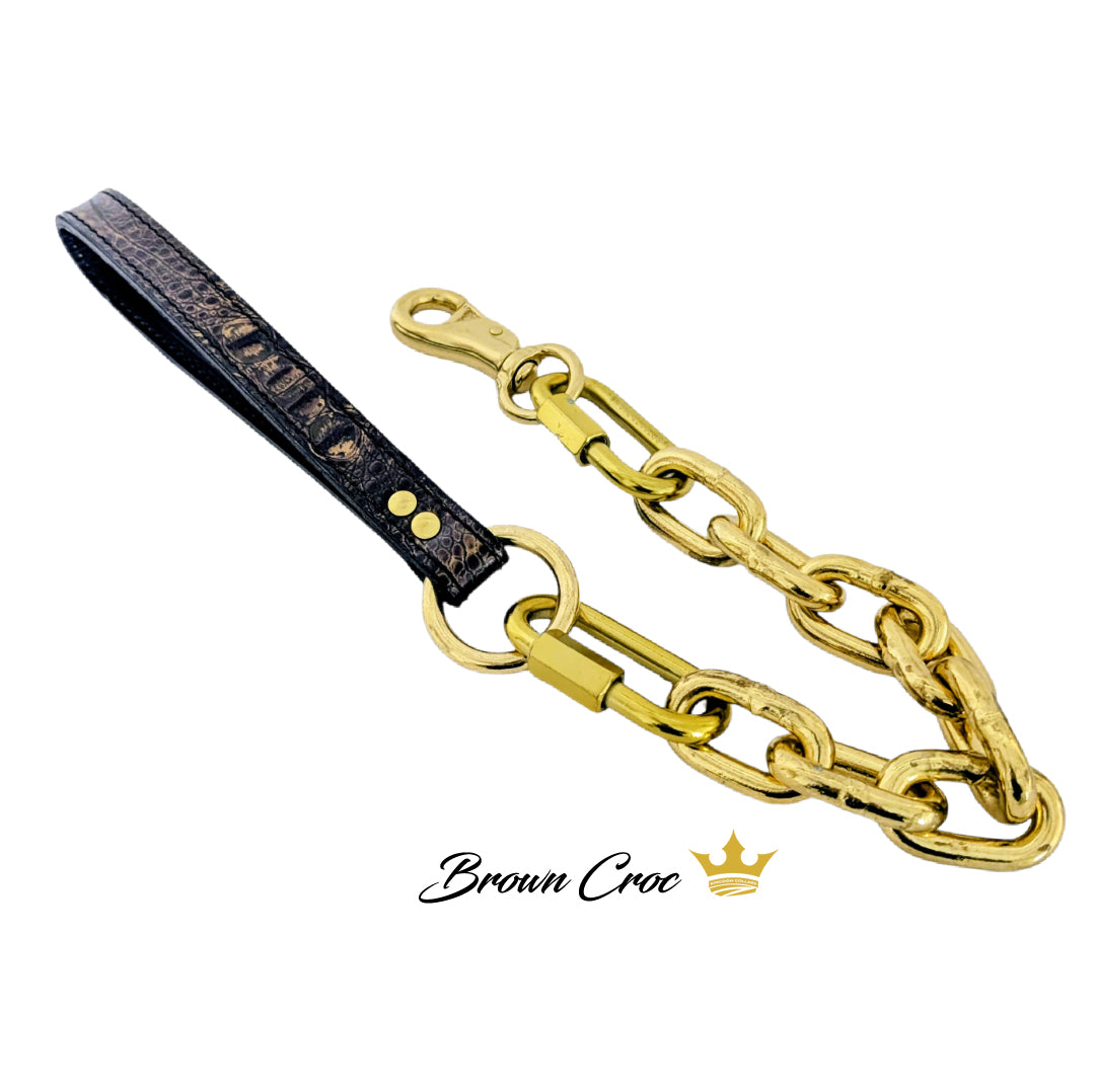 Gold chain dog collar with black leather strap on a white background, featuring 'Brown Croc' brand.